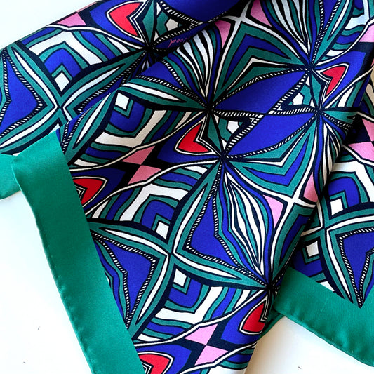 Close-up of Hearts and Stripes silk showing red hearts, blue, teal and white stripes and a teal edge